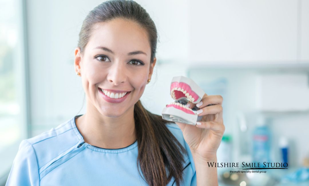 general dentistry woman holding dentures general dentistry woman holding dentures