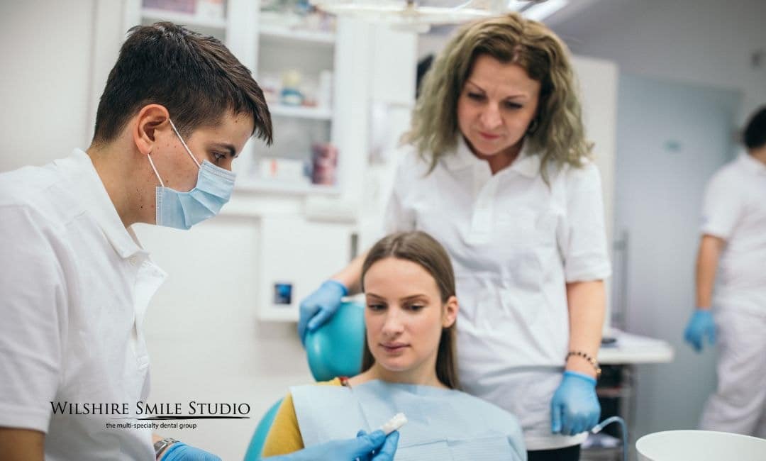 dentists discussing teeth with new patient dentists discussing teeth with new patient
