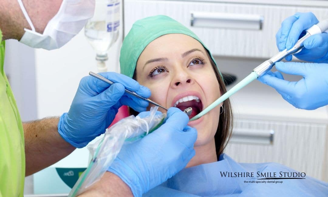 dentists working inside womans mouth dentists working inside womans mouth