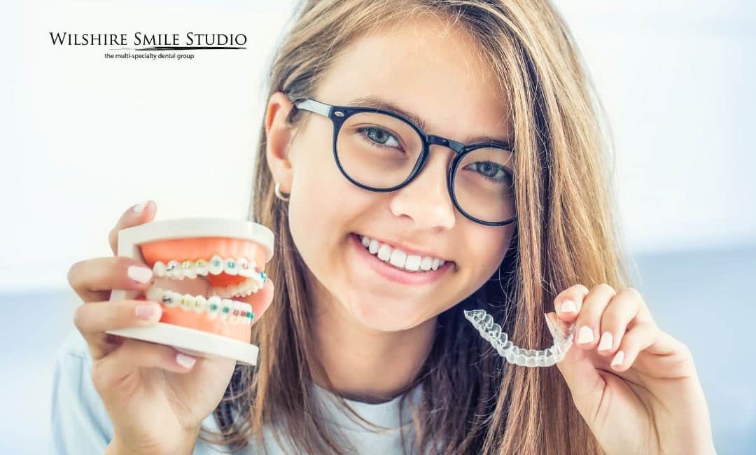 girl holding invisalign retainer girl holding invisalign retainer
