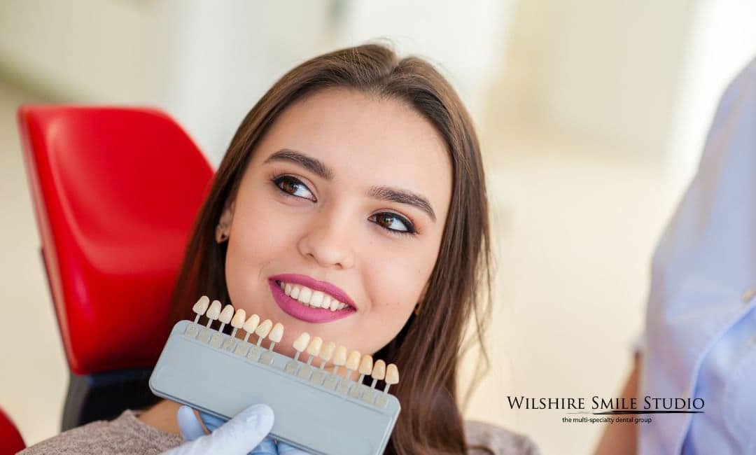woman checking shade of teeth woman checking shade of teeth