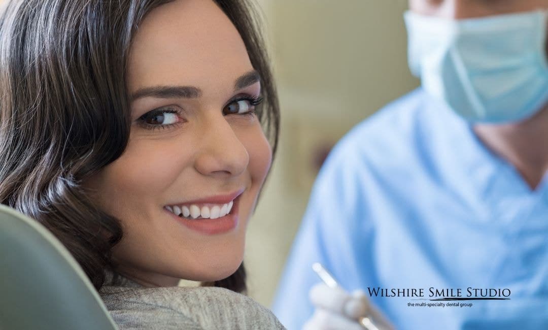 woman looking back and smiling in dental chair woman looking back and smiling in dental chair