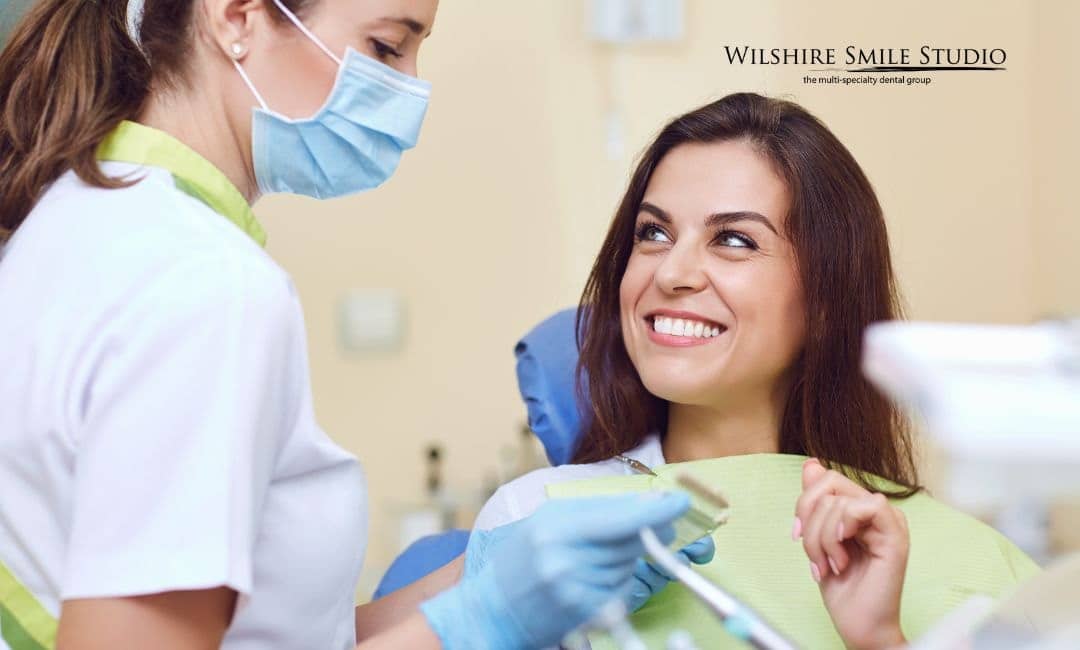 young woman talking to dental nurse young woman talking to dental nurse